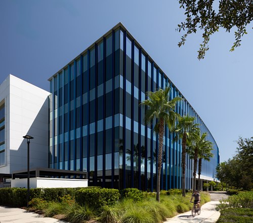 Blue glass exterior wide shot of Tavistock Building B at Lake Nona, designed by HuntonBrady Architects