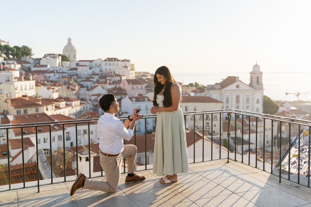 Sunset marriage proposal overlooking the rooftops of Alfama in Lisbon