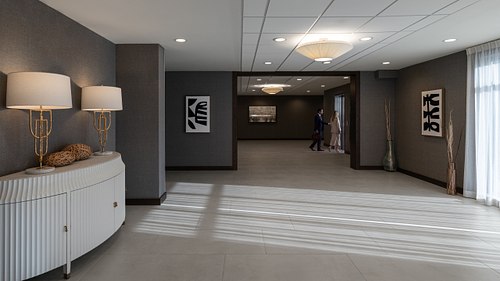 Corporate hotel lobby with business people walking into elevator.