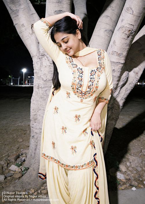 Outdoor smiling portrait featuring Nupur Ahuja in a yellow patiyala suit.