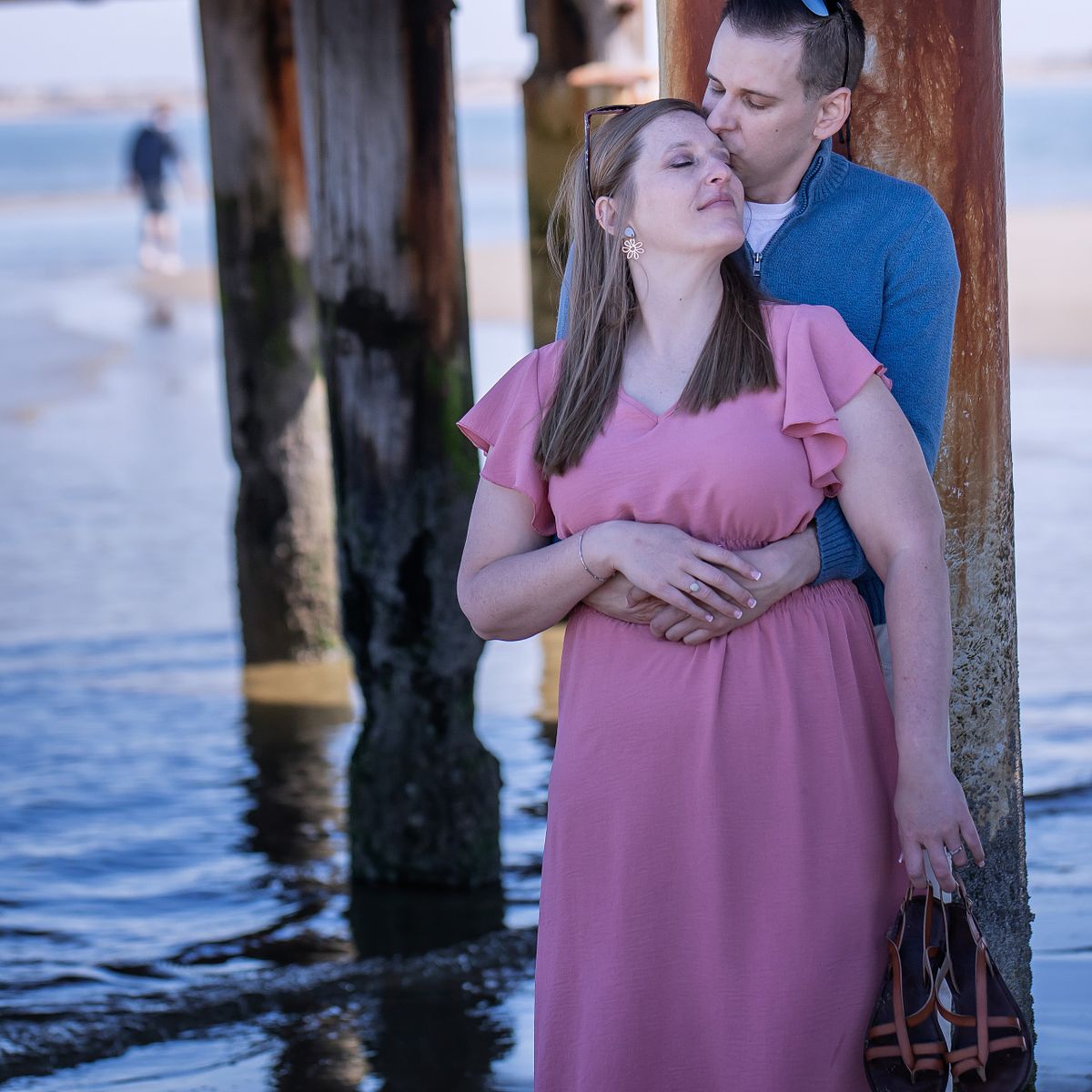 Emotional, documentary-style portrait of a newlywed couple enjoying a quiet moment away from the crowd on the Delaware coast.