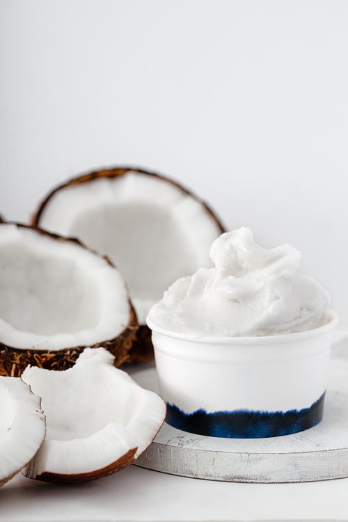Coconut ice cream in cup on white background