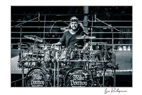 Mike Portnoy Live Concert Print  Horizontal black and white image of Mike Portnoy performing behind a large double bass drum kit during a live concert