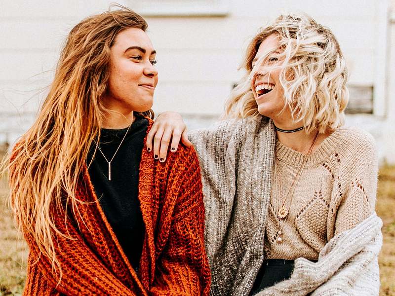 two perimenopause women sharing their stories and laughing
