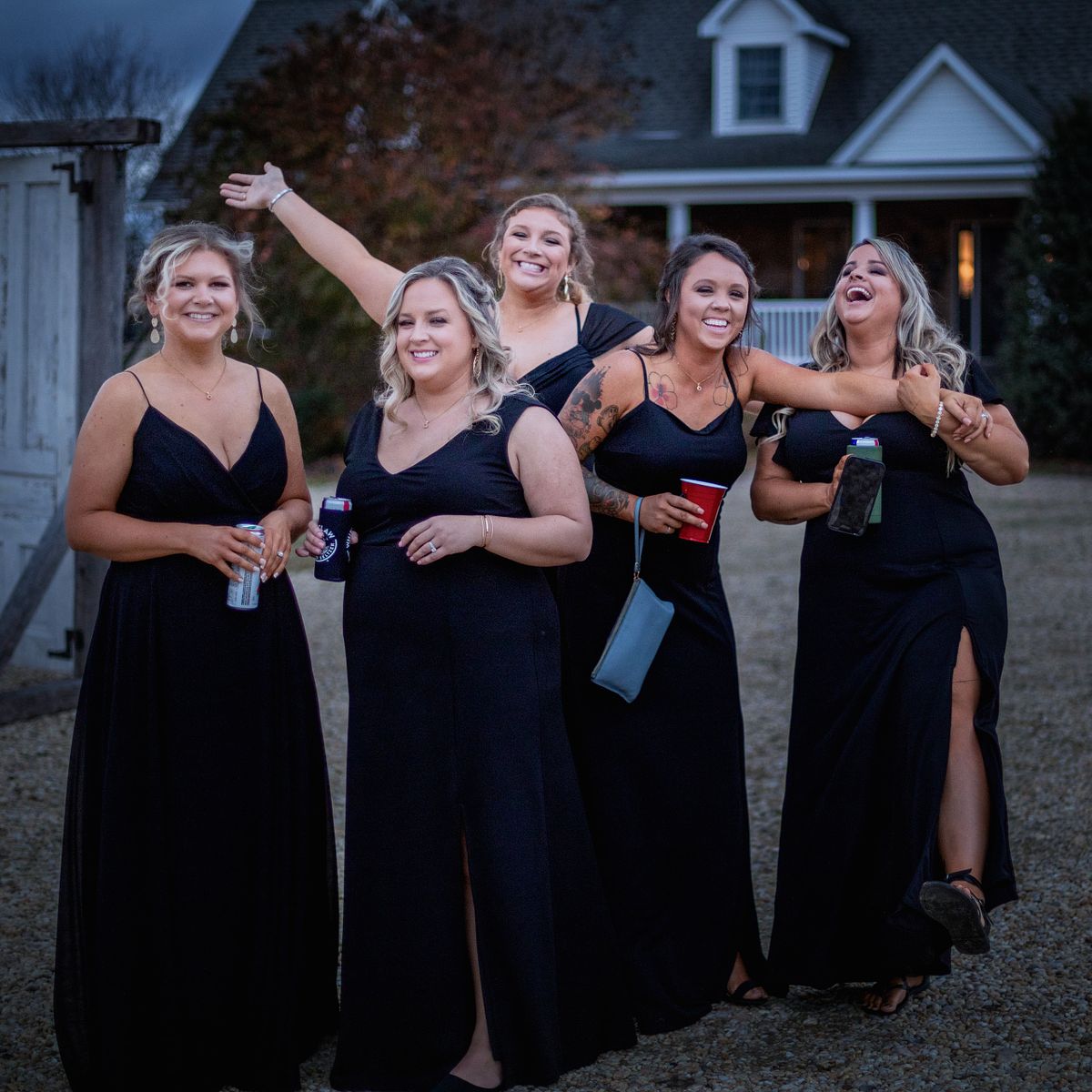 bridesmaids laughing and posing on the grounds of cohee farm in williamsburg, md