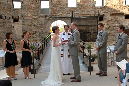 Intimate moment during wedding ceremony of bride and groom holding hands- black hills wedding venue