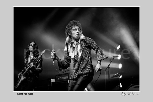 Horizontal black and white image of Greta Van Fleet members Sam Kiszka and Josh Kiszka performing on stage