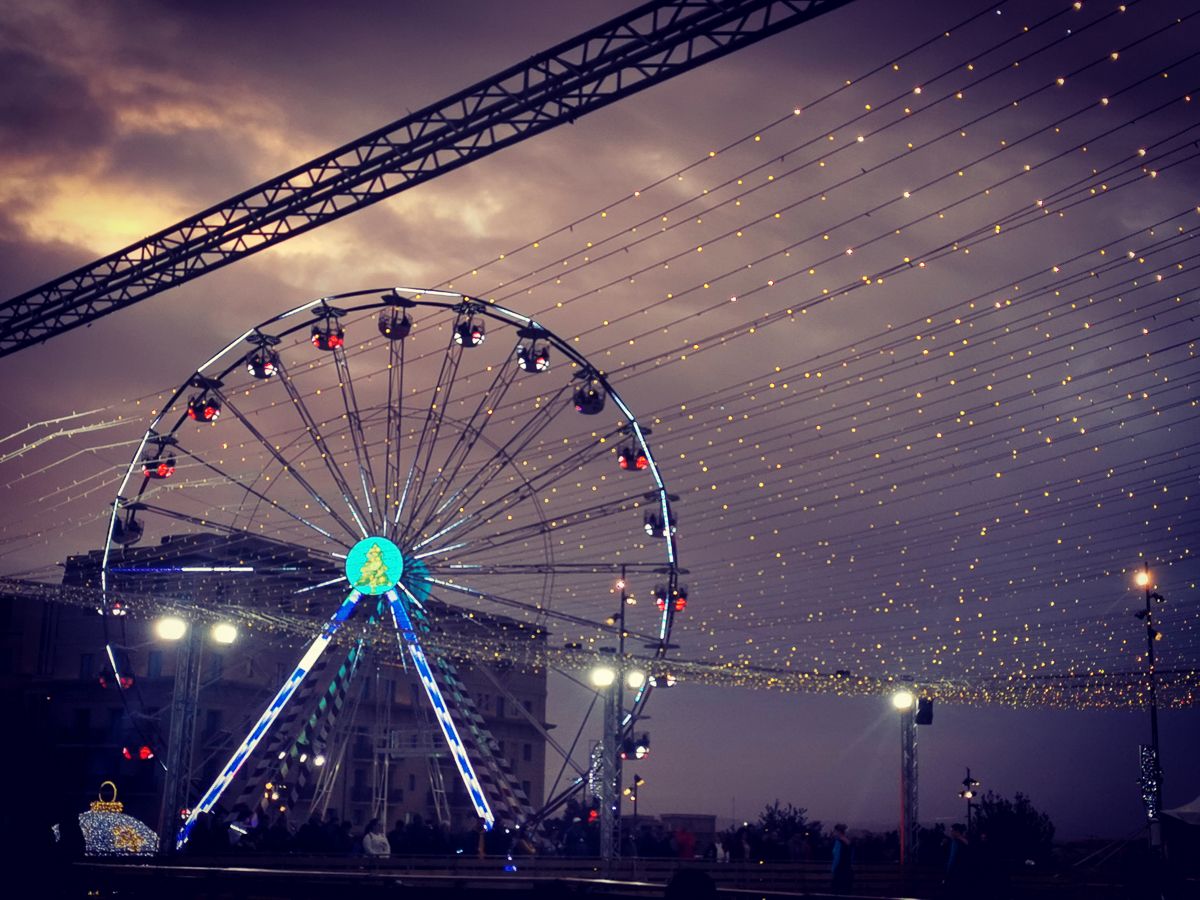 Christmas lights and a Ferris wheel in Valletta, Malta, during the festive season.
