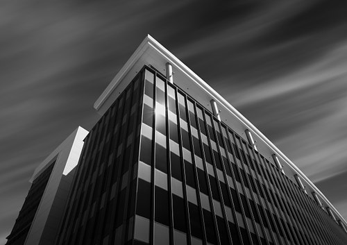 Modern glass facade of Tavistock Building B in Lake Nona Town Center, designed by HuntonBrady Architects and developed by Tavistock.