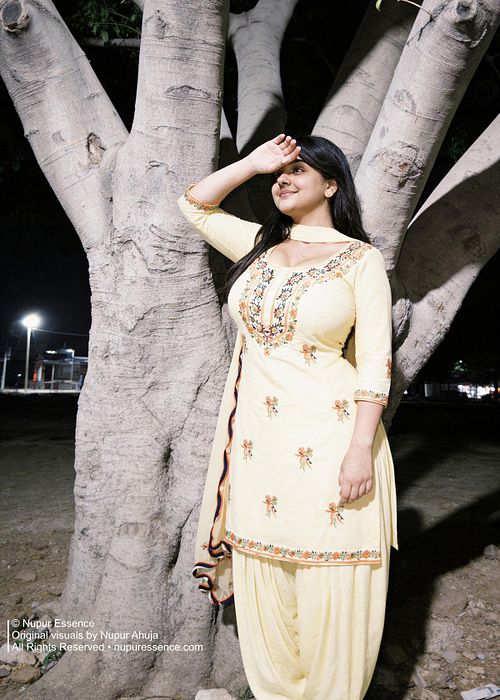 Night street portrait featuring Nupur Ahuja in a yellow Punjabi suit