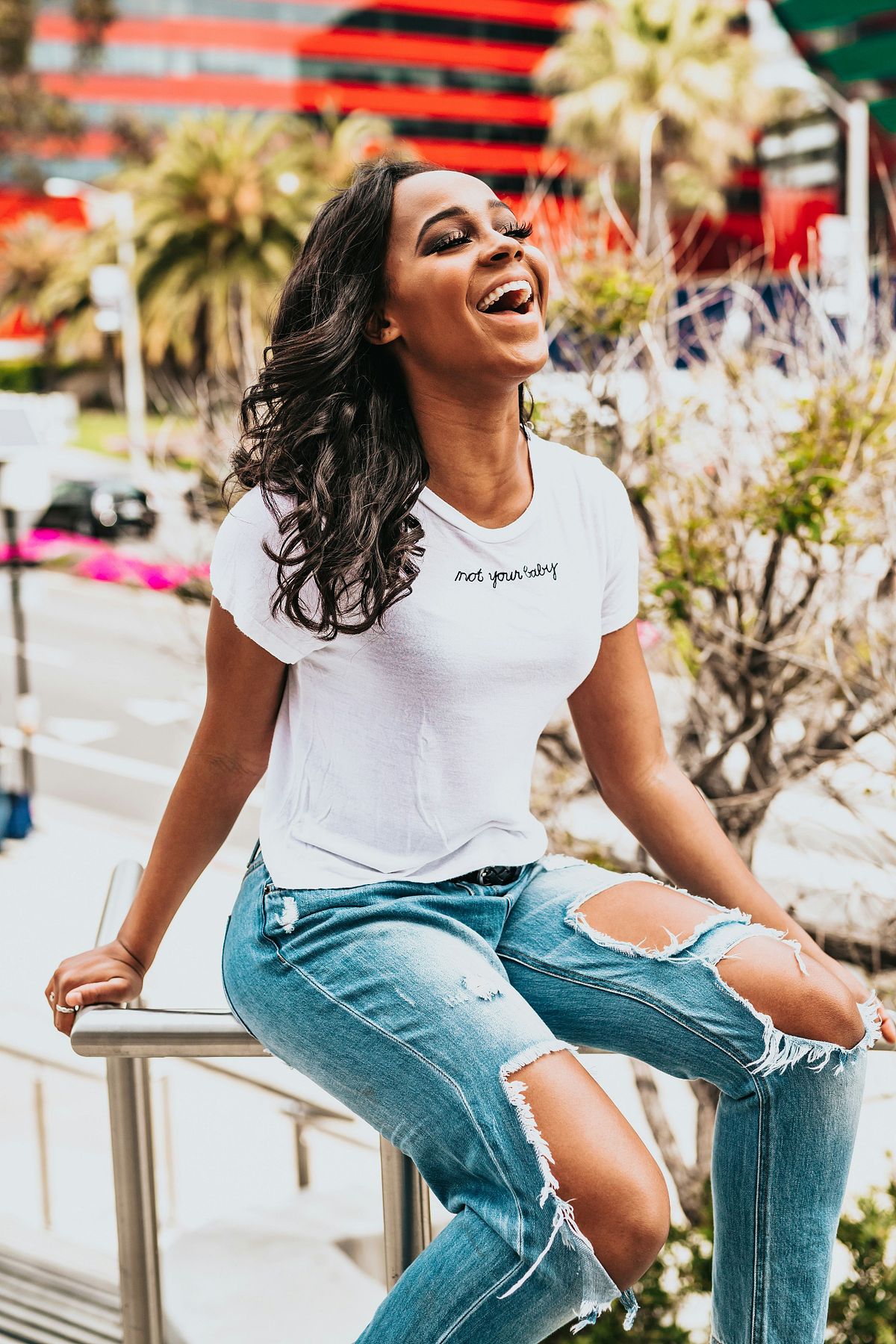 High school senior posing confidently outdoors in natural light.