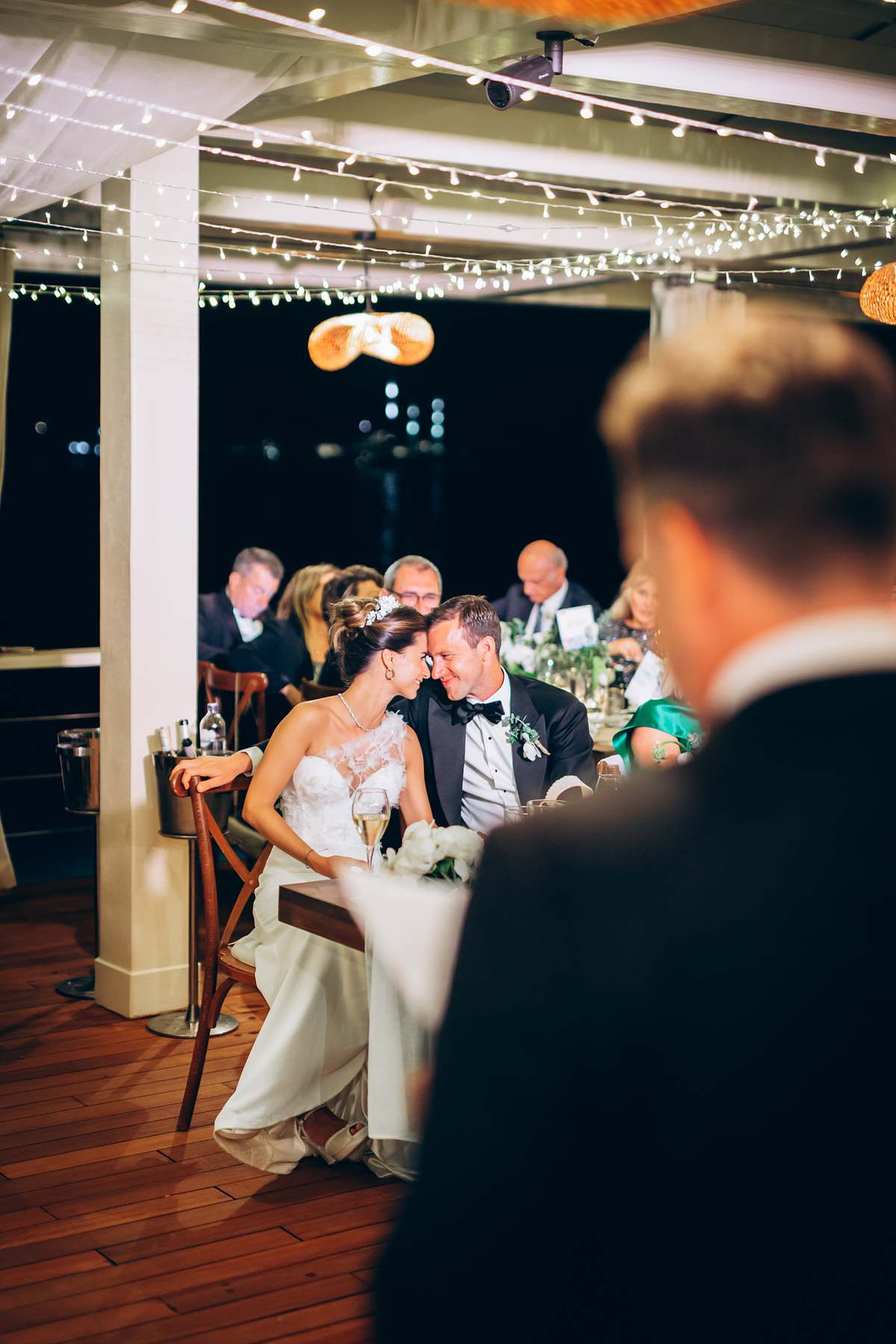 Bride and groom sharing a quiet moment at their reception table
