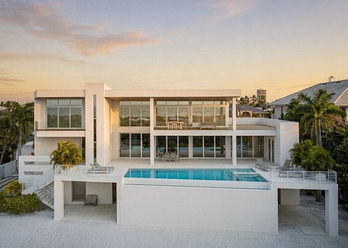 Aerial drone photograph of a luxury Lido Key residence at sunset.