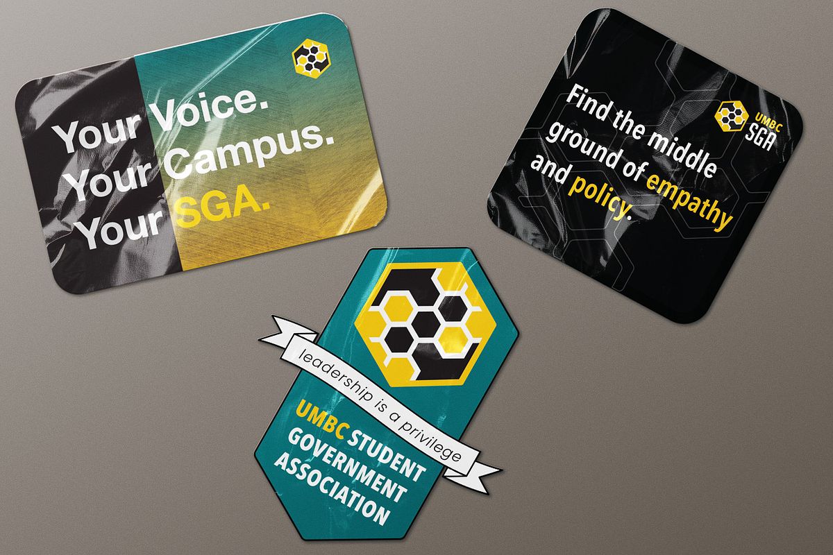 3 umbc sga stickers on grey background