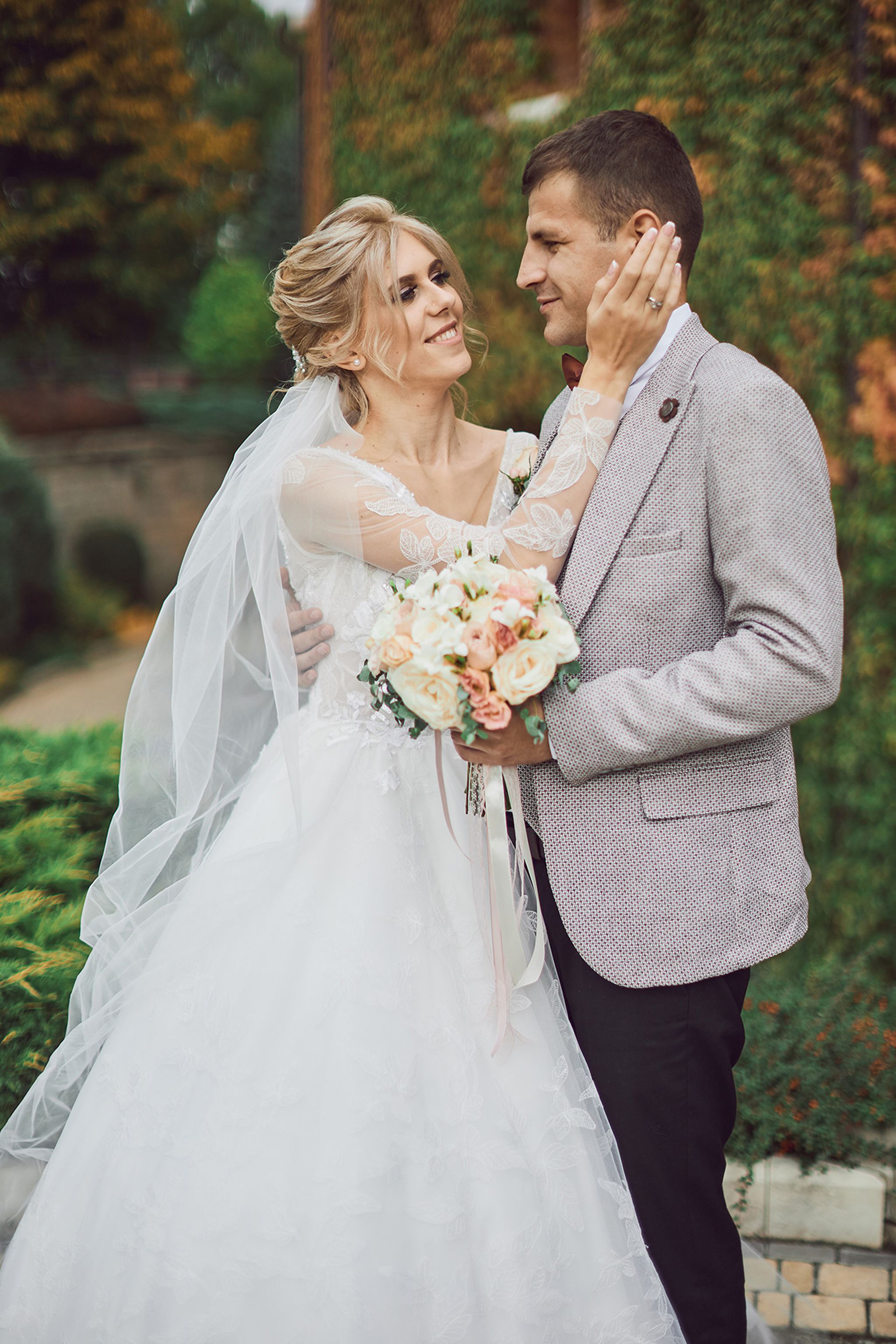 Romantic bride and groom portrait in an autumn garden