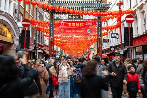 People during Lunar New Year celebrations in Chinatown, London, UK