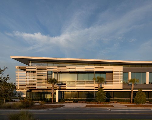 Architectural exterior photography of the Florida Public Utilities (FPU) Headquarters in Yulee, Florida, featuring a modern commercial facade with glass and metal elements.
