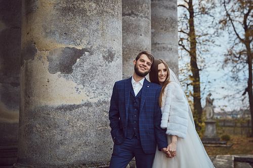 Wedding portrait among the historic columns of St. Joseph’s Church
