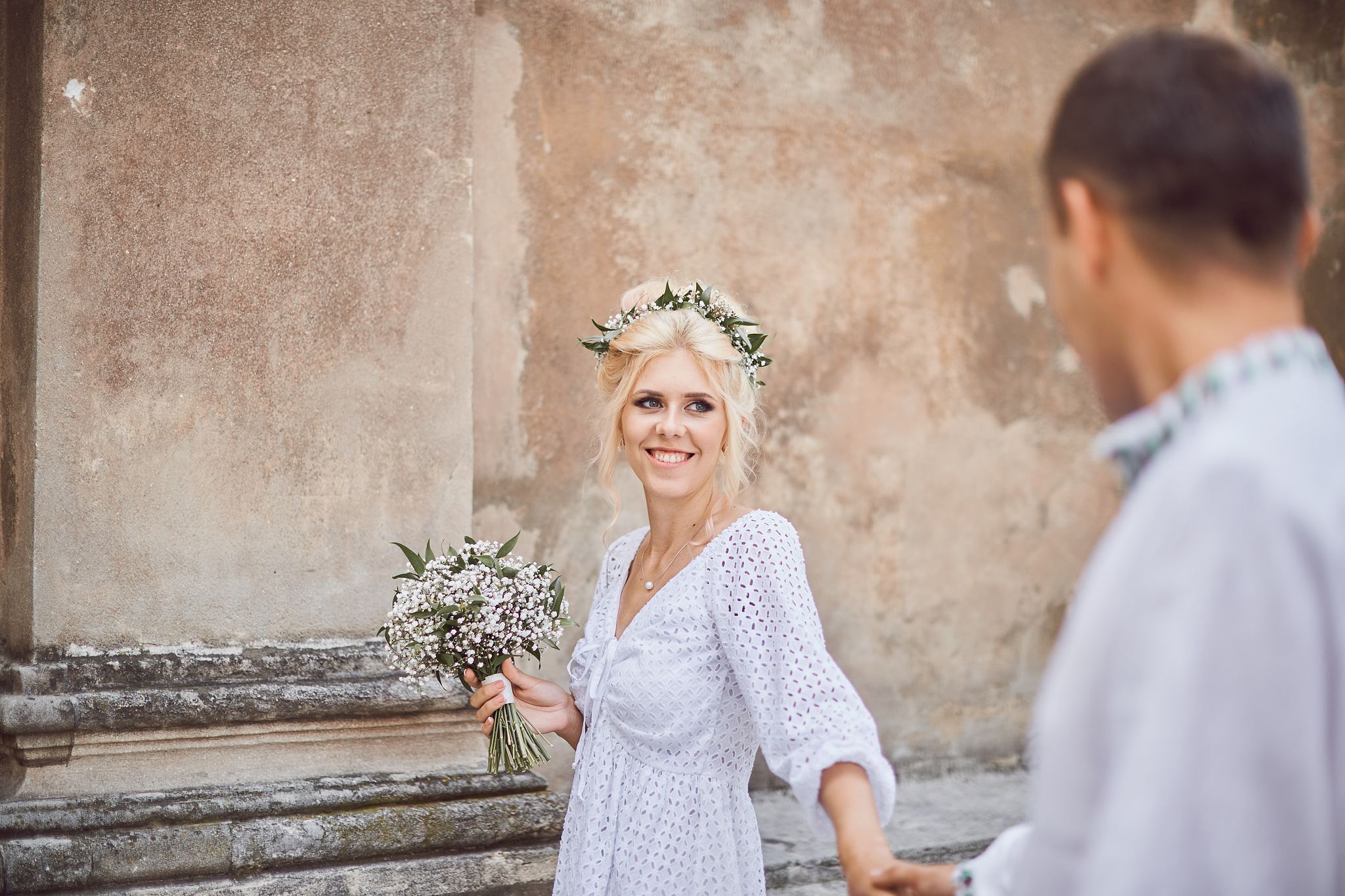 Bride and groom walking together through the city streets
