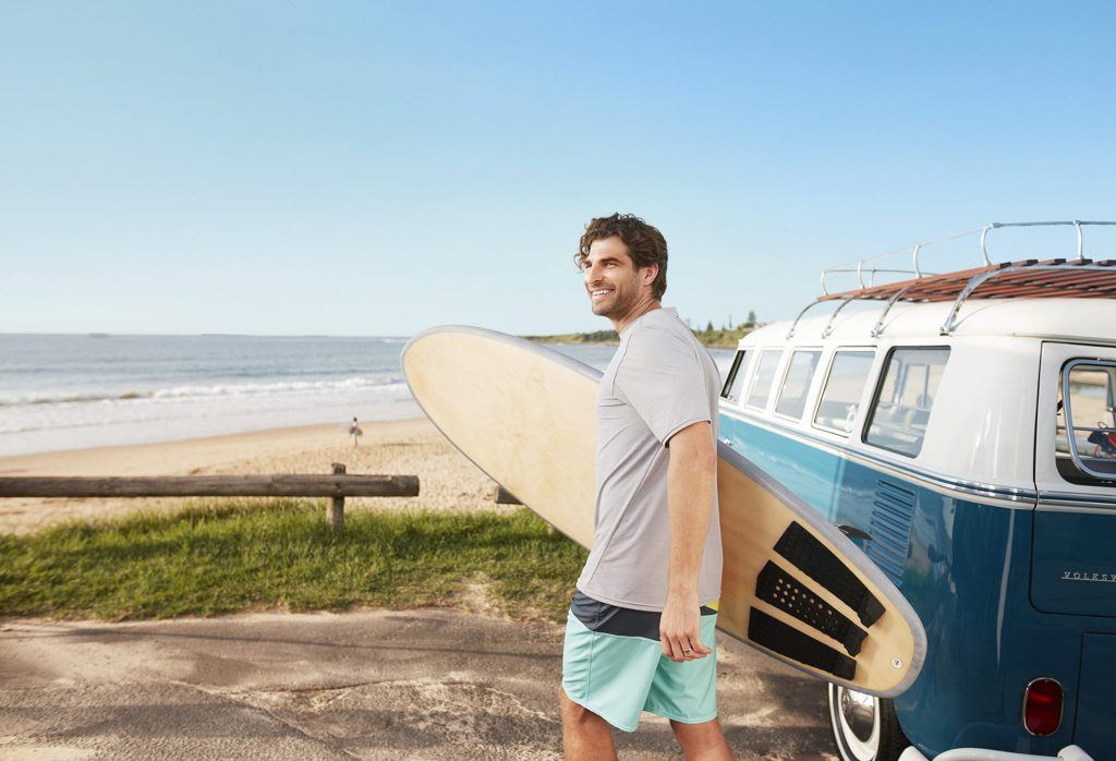 Beach Dude with surfboard leaving his van for the beach at Wollongong