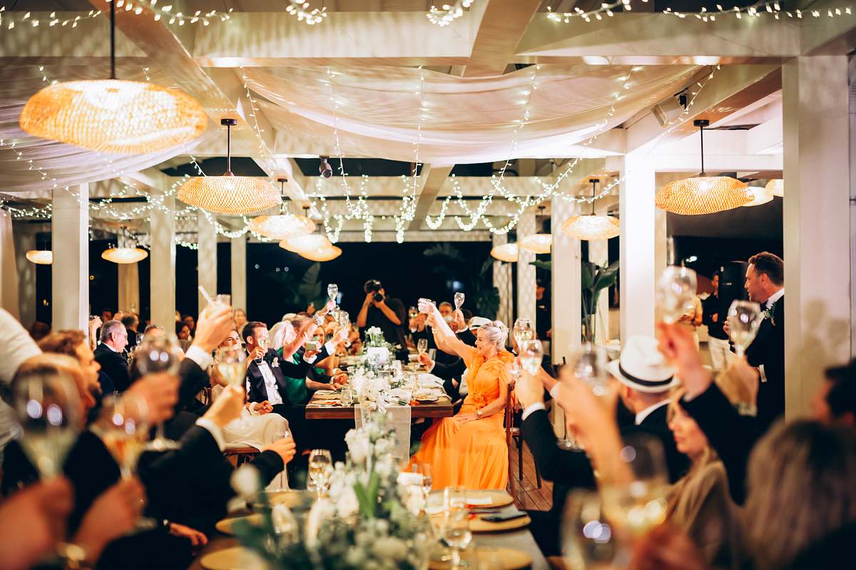 Wedding guests raising their glasses for a toast at D-Resort Göcek