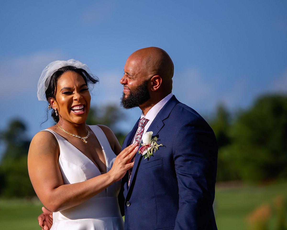 bride and groom smiling after ceremony on the paved walk way