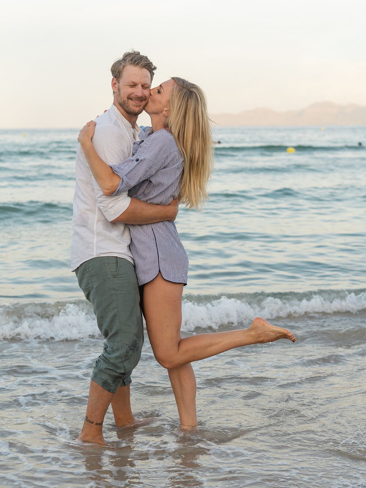 Couple embracing on a beach near Lisbon