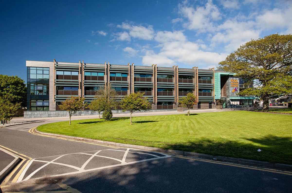 Pool Innovation Centre Cornwall, showing contemporary three-storey office building with green landscaping.