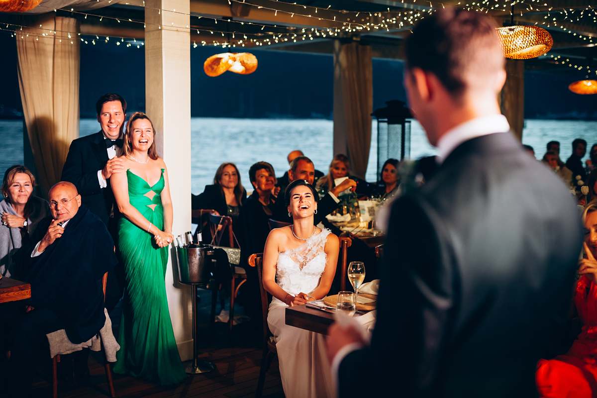 Bride laughing as the groom gives a wedding speech at D-Resort Göcek