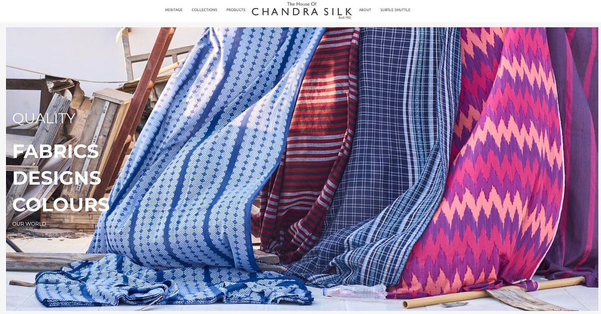 Chandra Silk homepage with an Estd. 1952 line under the logo and a full-bleed wall of patterned fabric