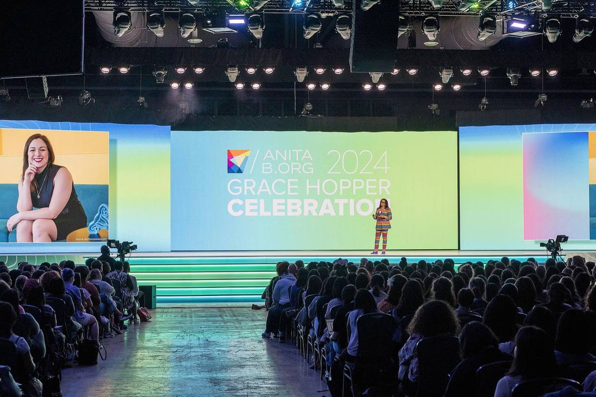 Conference photographer in Philadelphia documenting a large professional conference with a keynote speaker, branded stage, and engaged audience.