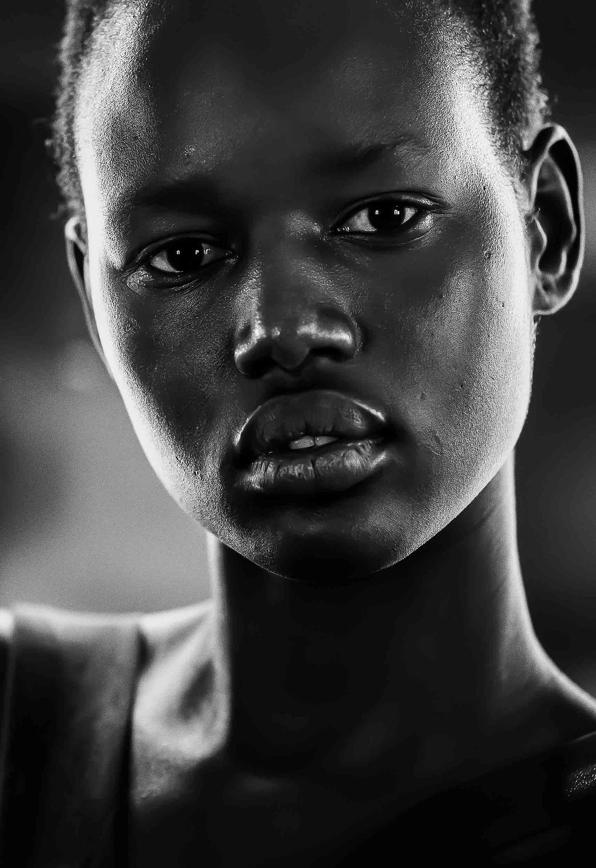 Portrait of a dark skinned girl lit dramatically form both sides.