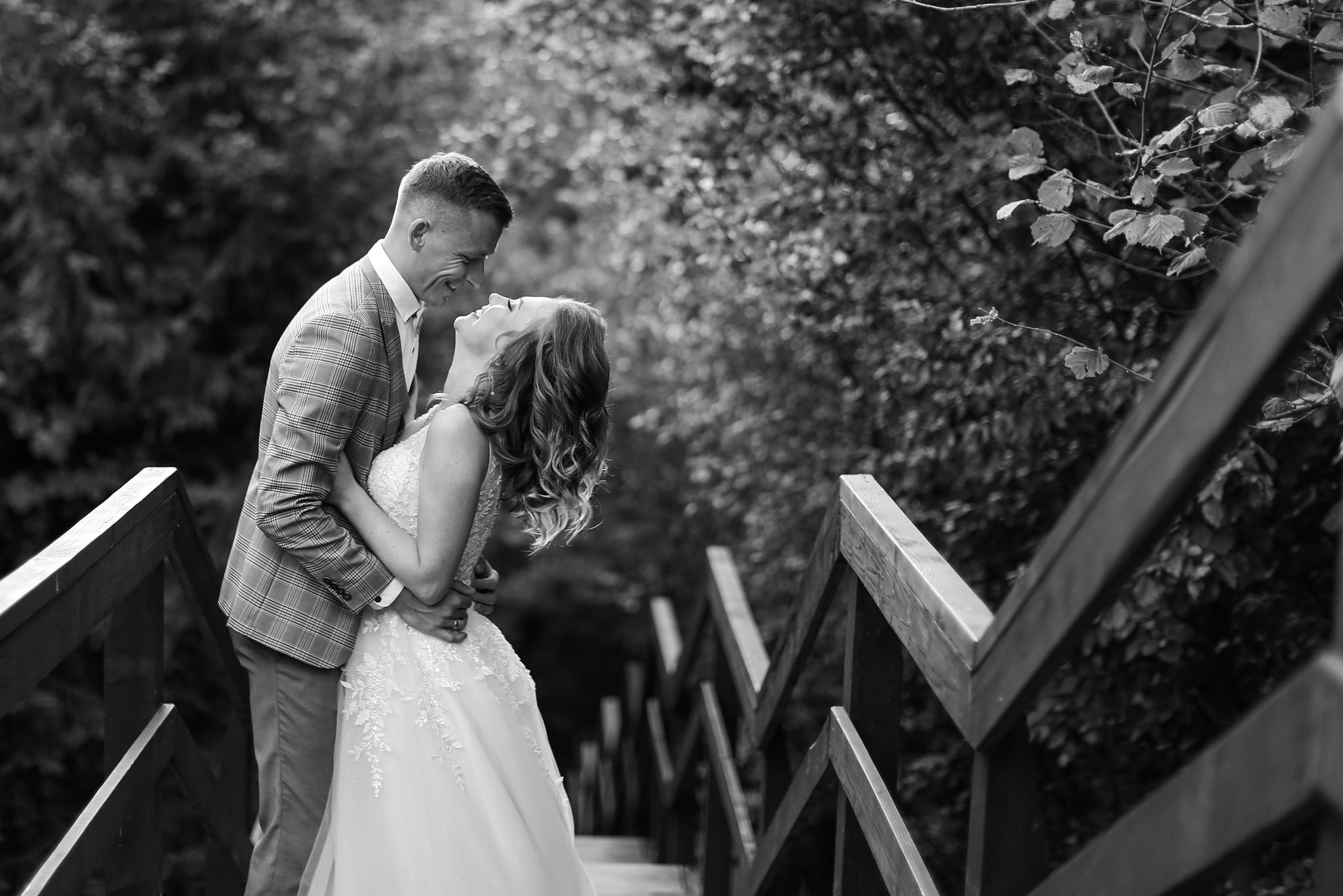 Bride and groom on the wooden steps at Tustan Fortress, Ukraine