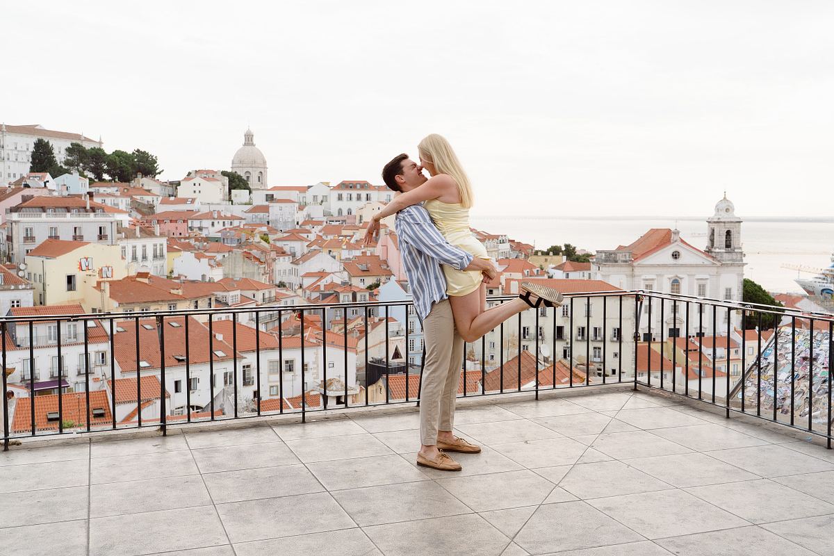 Newly engaged couple embracing after a surprise proposal in Lisbon