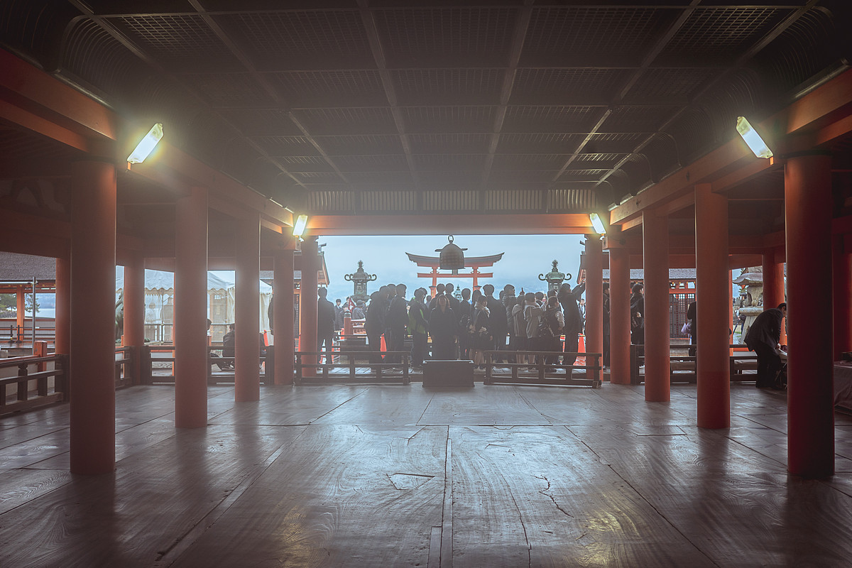 Les couloirs sur pilotis du sanctuaire Itsukushima-jinja, piliers rouge vermillon et sol mouillé, Miyajima