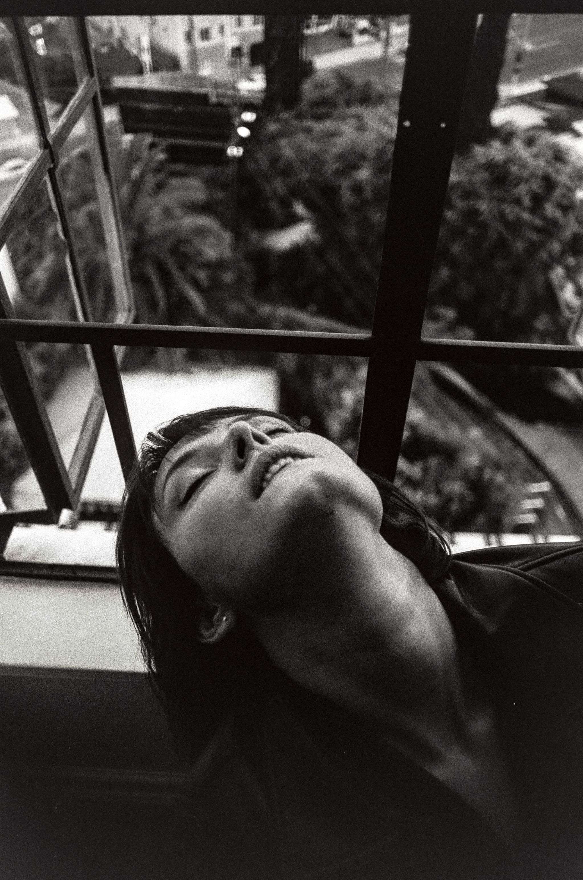 Copenhagen portrait photographer shoots model leaning her head out the window of room 79 at the Chateau marmont