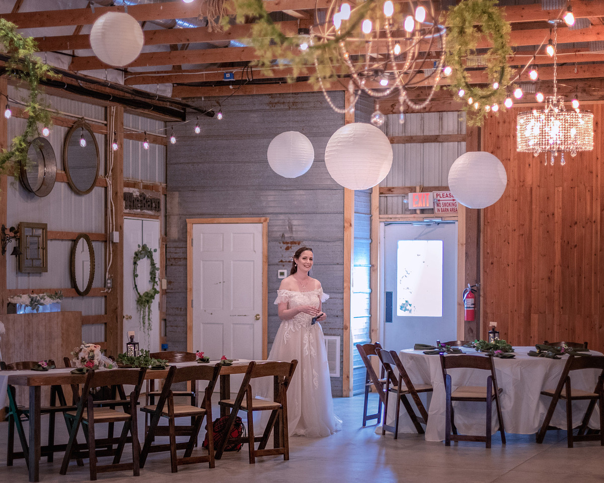 table arrangements at chickberry farm with the bride inspecting the tables before the ceremony