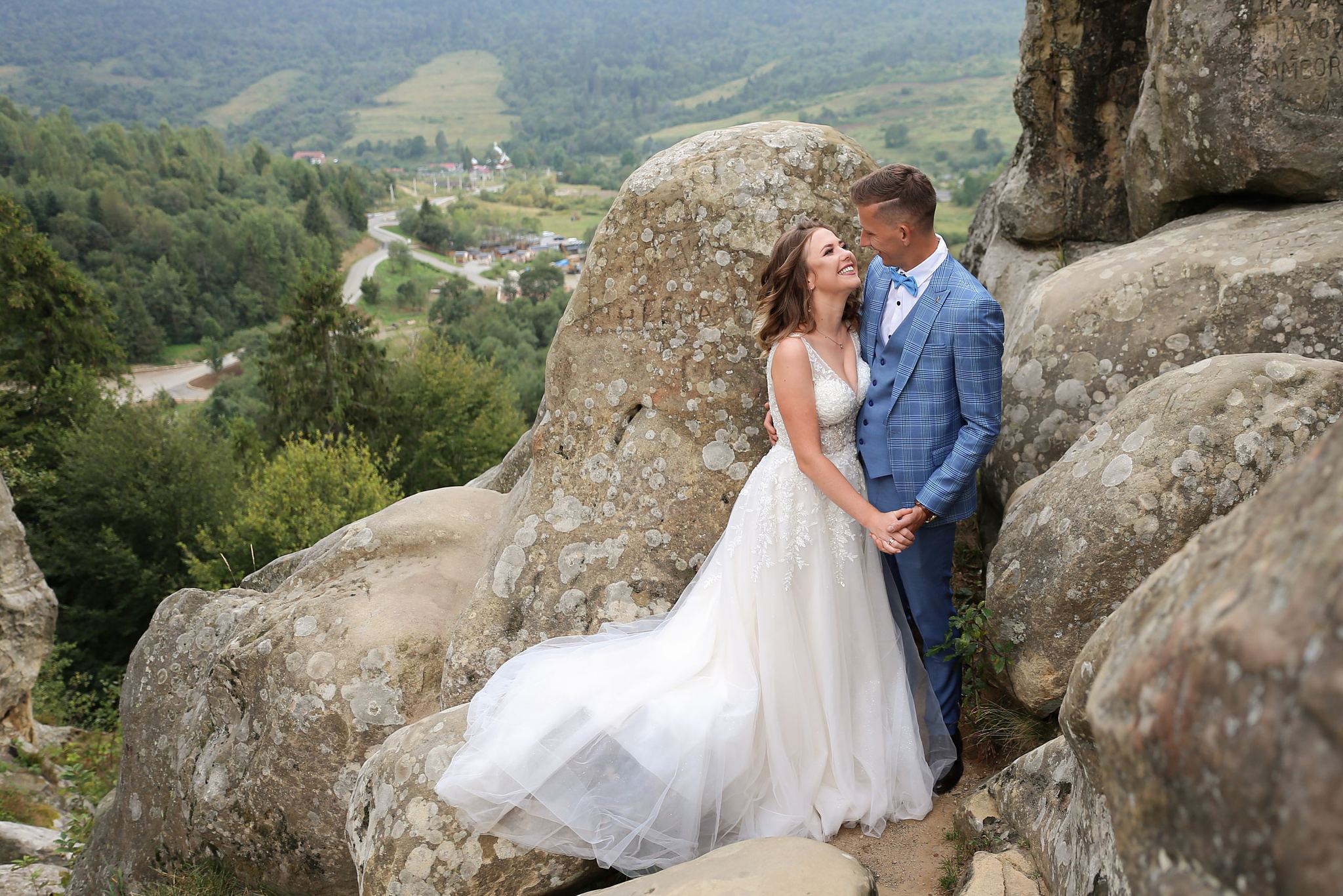 Bride and groom wedding portrait among the rocks at Tustan Fortress, Ukraine