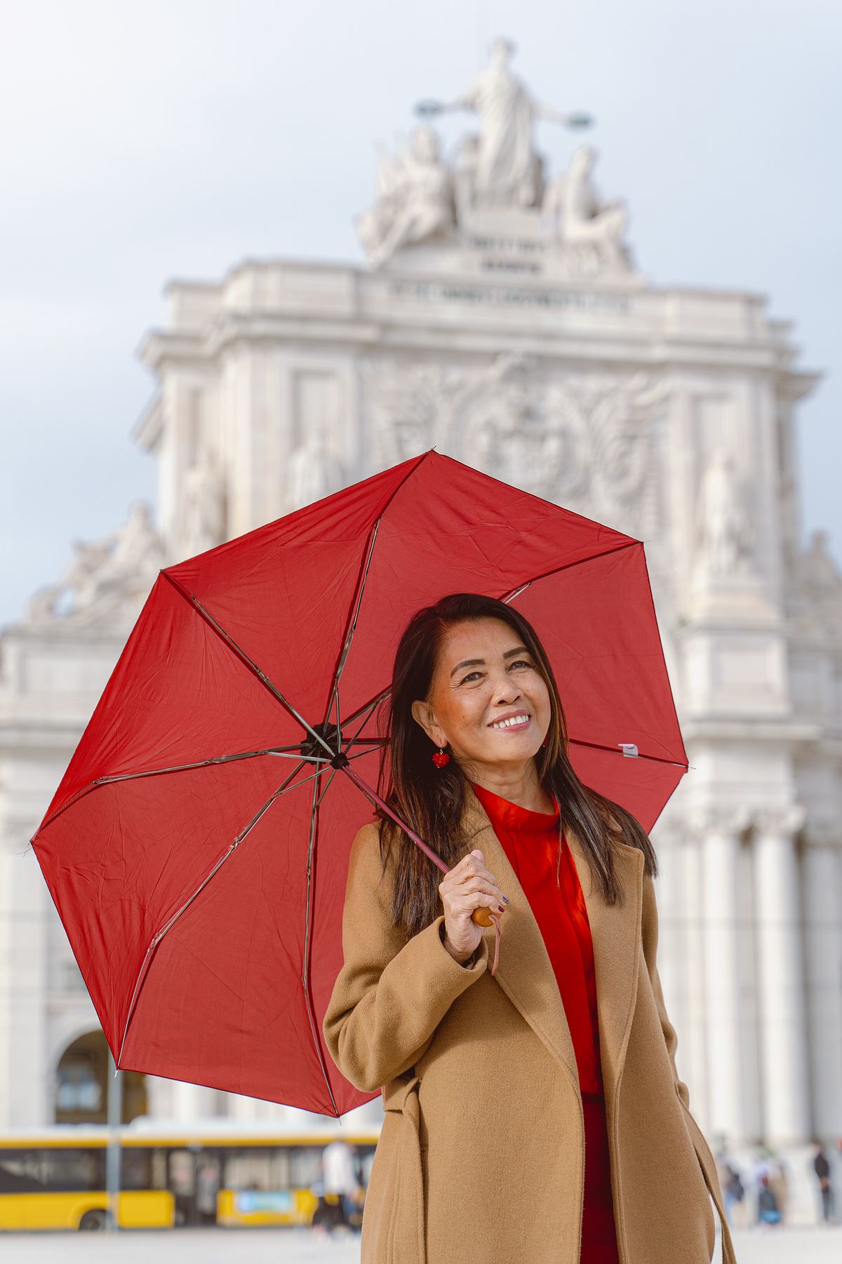 Woman with a red umbrella at Rua Augusta Arch
