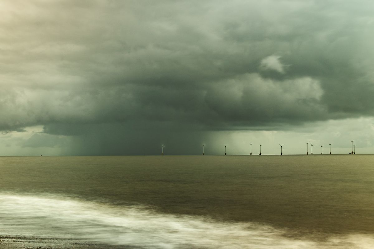 A massive, low-hanging storm cell and dark shelf cloud over the North Sea and sandy beach at Great Yarmouth, Norfolk