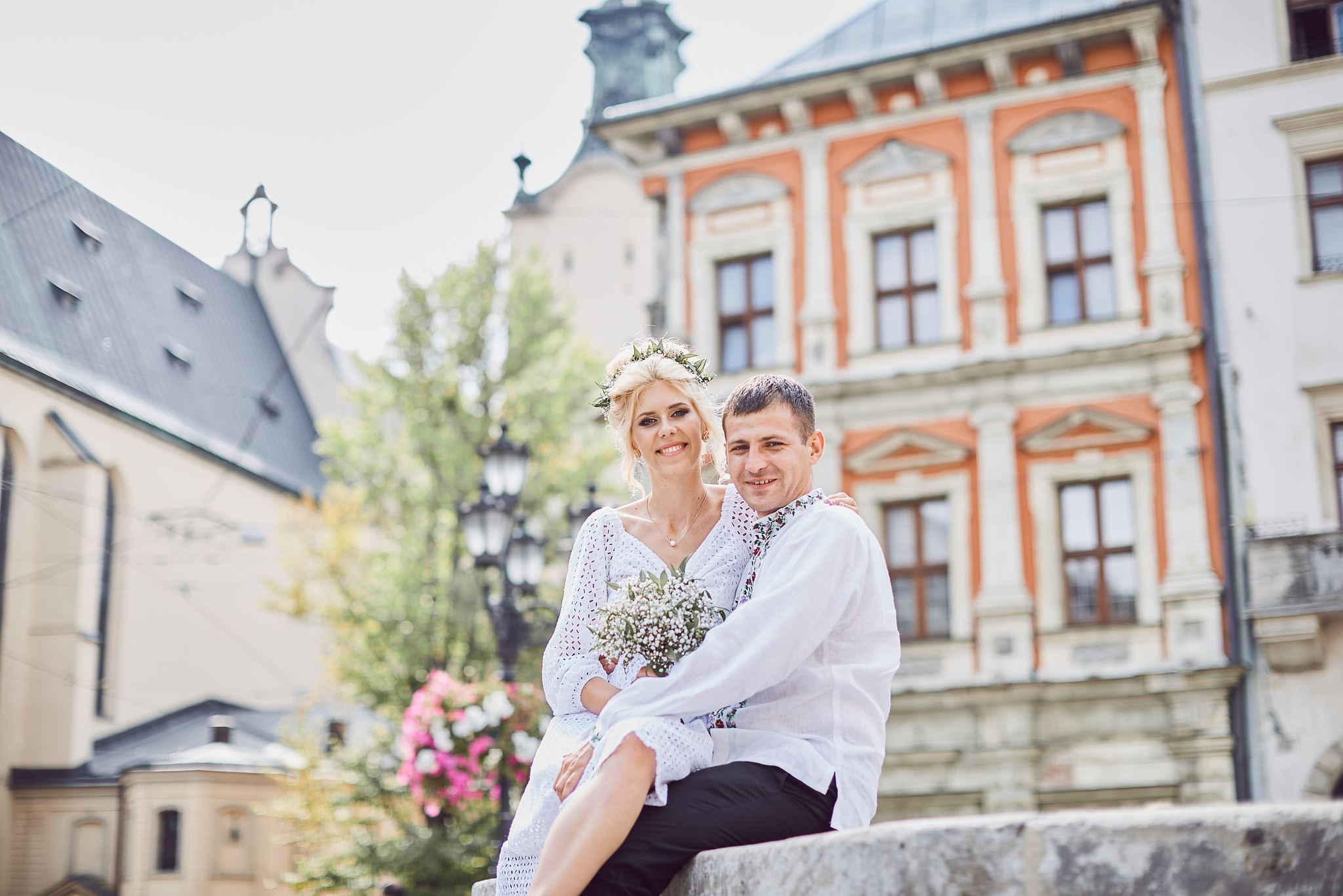 Bride and groom standing together on a historic street