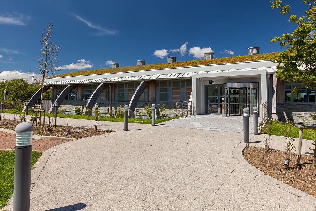 IR building in Cornwall with living roof and stone detailing.