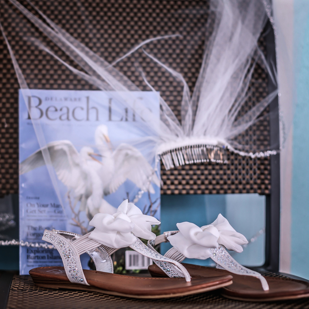 still life of bridal shoes and veils on a chair, with the Delaware Beach magazine behind the veil