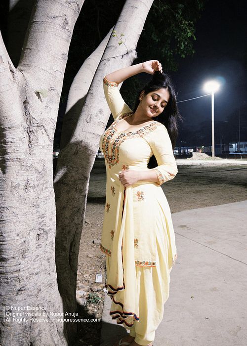 Cinematic fashion portrait featuring Nupur Ahuja in a yellow embroidered Punjabi suit