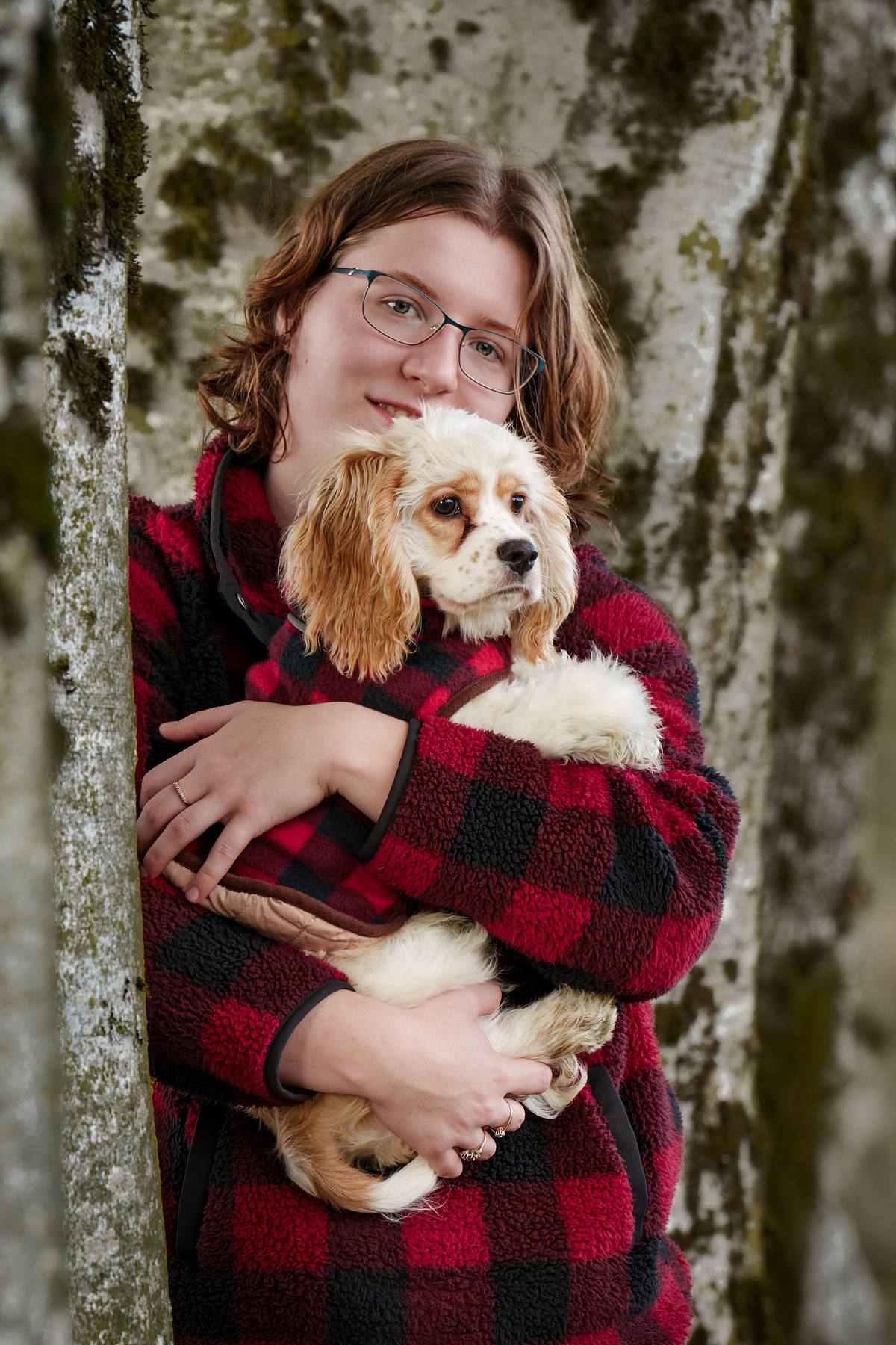 Young woman and her cocker spaniel at the park on an autumn day.