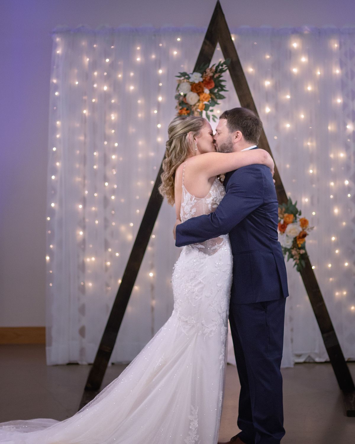bride and groom hugging tightly and kissing after wedding ceremony at ross station