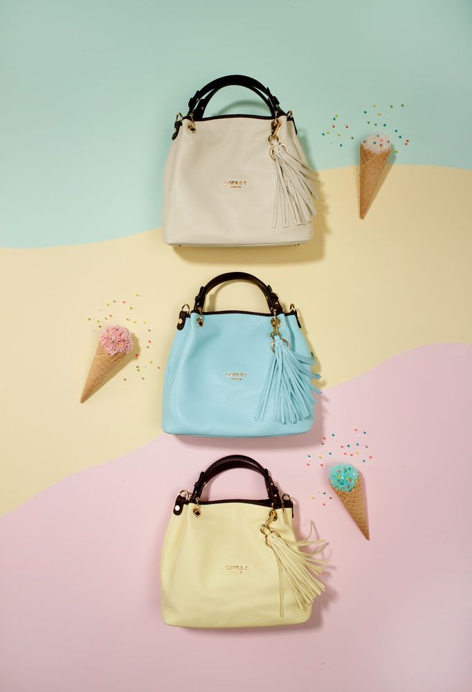 cream, blue and yellow handbags set against pastel background with ice cream props