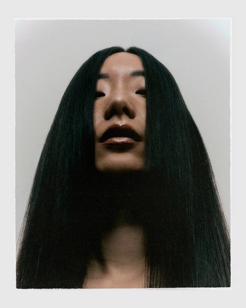 Editorial beauty photography focused on hair makeup and expression with dramatic colors