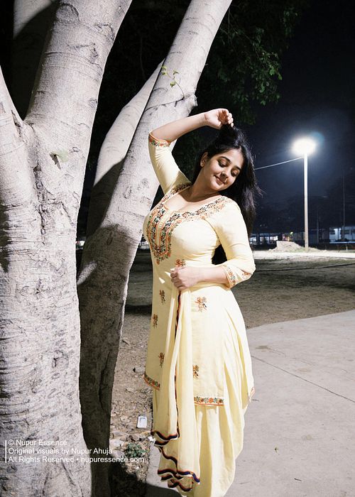 Punjabi fashion portrait featuring Nupur Ahuja in a yellow traditional outfit during an evening shoot