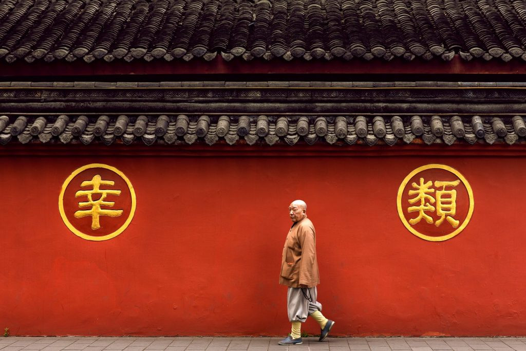 Completely surrounded by the color RED: the monk and the two Chinese symbols